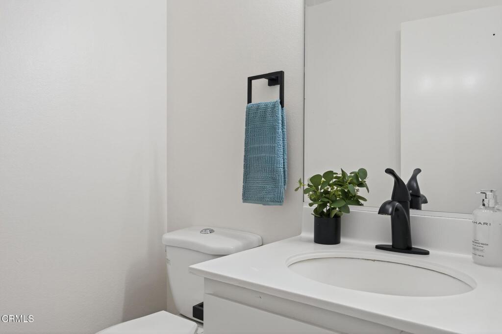1466 San Simeon Court, Unit 2 Ventura, CA 93003 - Photo 20 of 41 a bathroom with a sink a toilet and a mirror