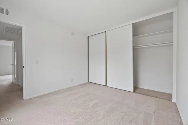 a view of an empty room with painting on the wall
