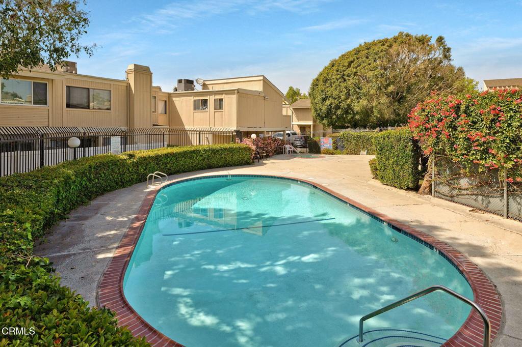 1466 San Simeon Court, Unit 2 Ventura, CA 93003 - Photo 30 of 41 a view of a swimming pool with a garden