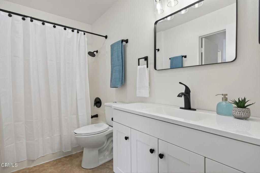 1466 San Simeon Court, Unit 2 Ventura, CA 93003 - Photo 35 of 41 a bathroom with a sink a toilet and a mirror