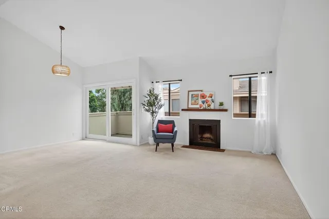 a view of a livingroom with an empty space and a fireplace