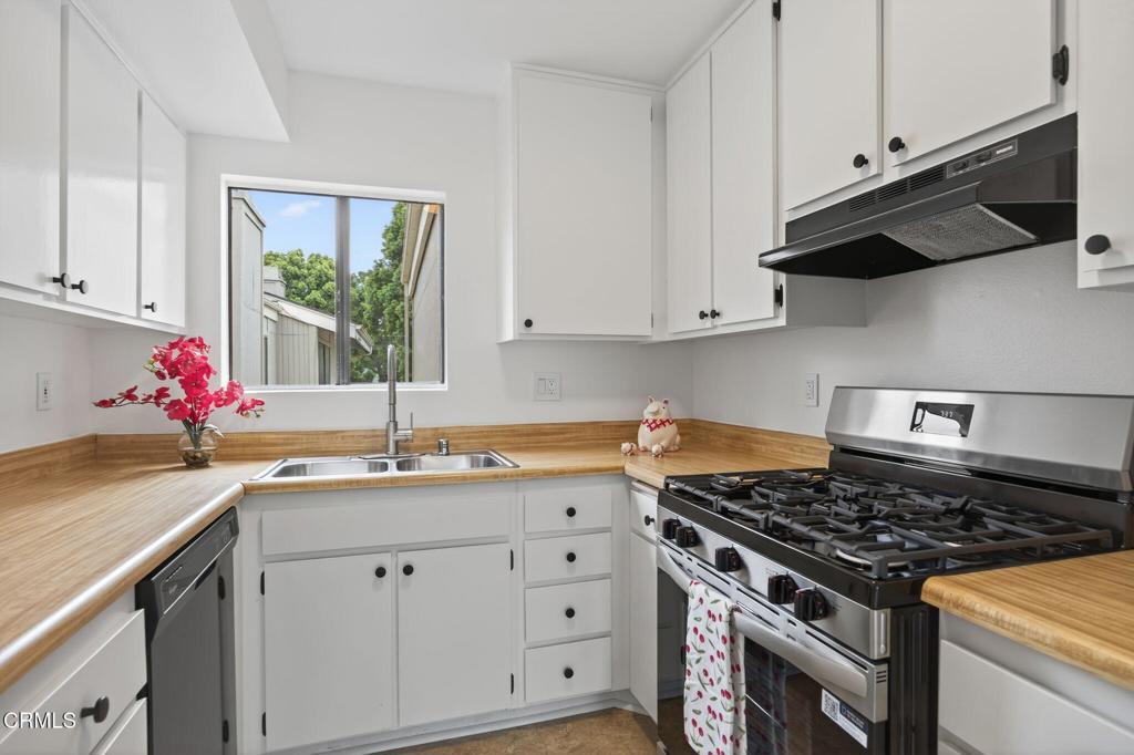 1466 San Simeon Court, Unit 2 Ventura, CA 93003 - Photo 7 of 41 a kitchen with granite countertop a sink stove and cabinets