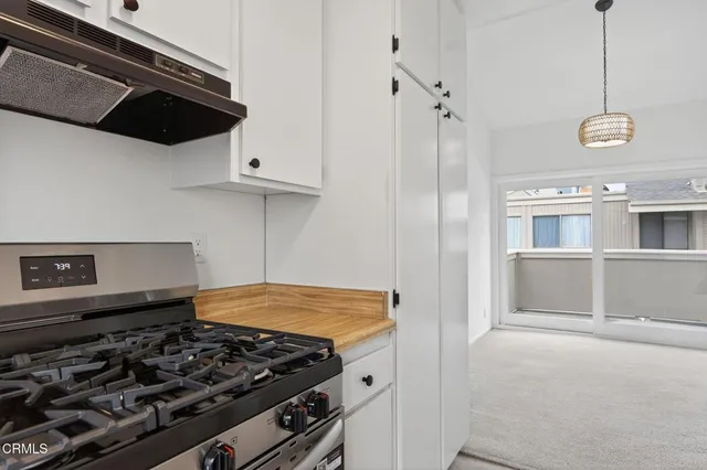 a kitchen with granite countertop a sink stainless steel appliances and cabinets