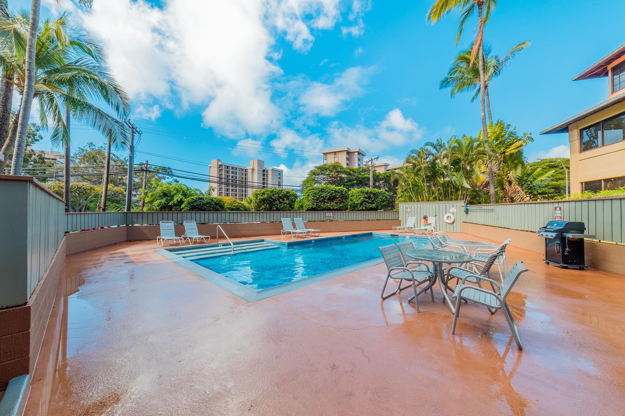 4310 Lower Honoapiilani Road, Unit 419 Lahaina, HI 96761 - Photo 24 of 32 a view of a swimming pool with a lounge chairs