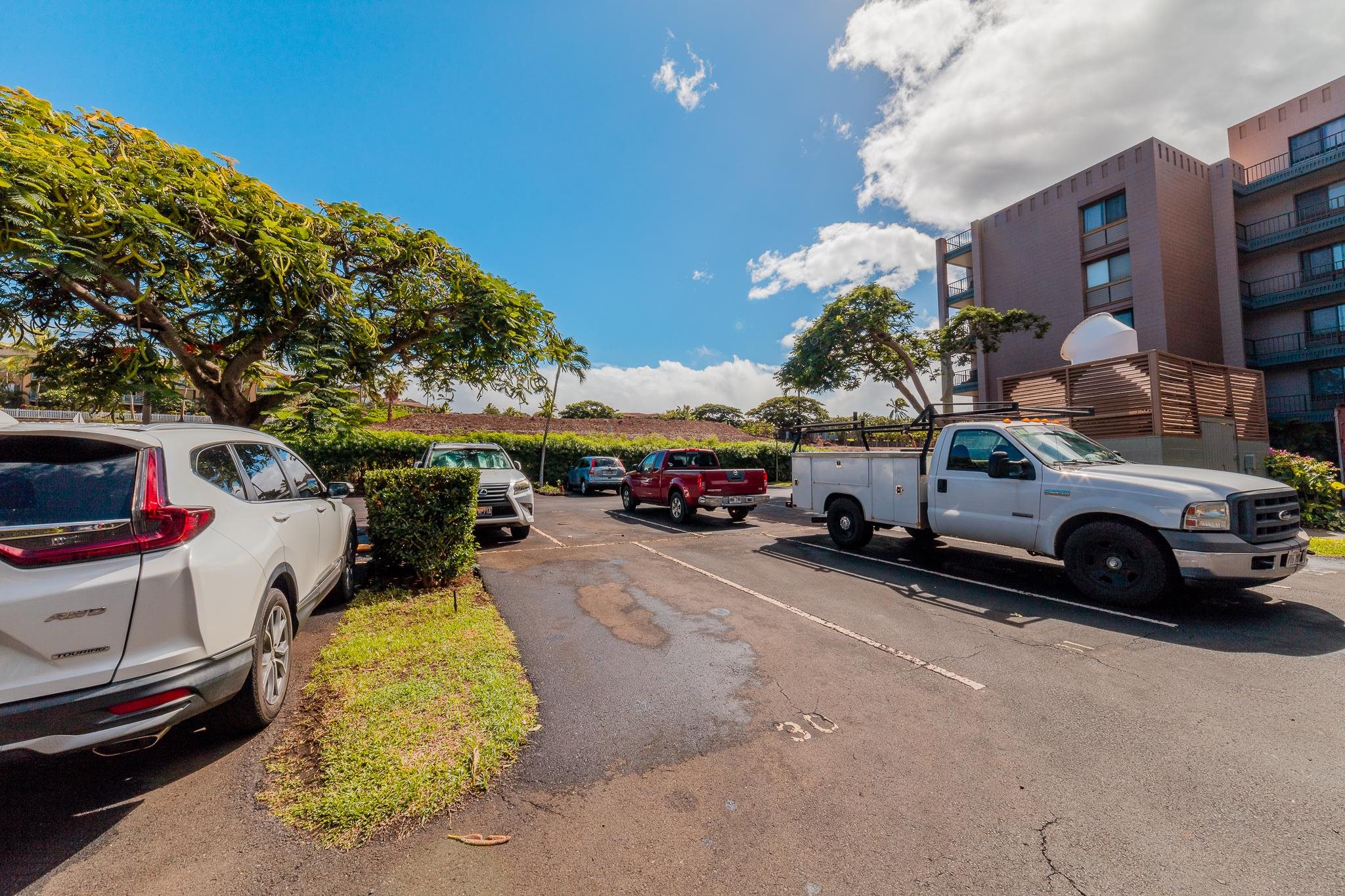 4310 Lower Honoapiilani Road, Unit 419 Lahaina, HI 96761 - Photo 25 of 32 a view of a cars park in front of a building
