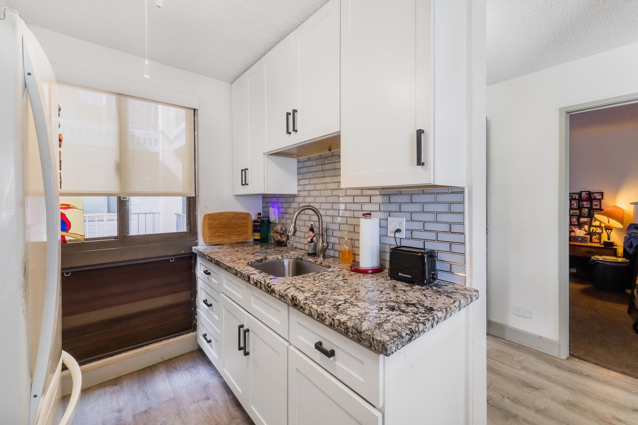 4310 Lower Honoapiilani Road, Unit 419 Lahaina, HI 96761 - Photo 4 of 32 a kitchen with granite countertop a stove and cabinets