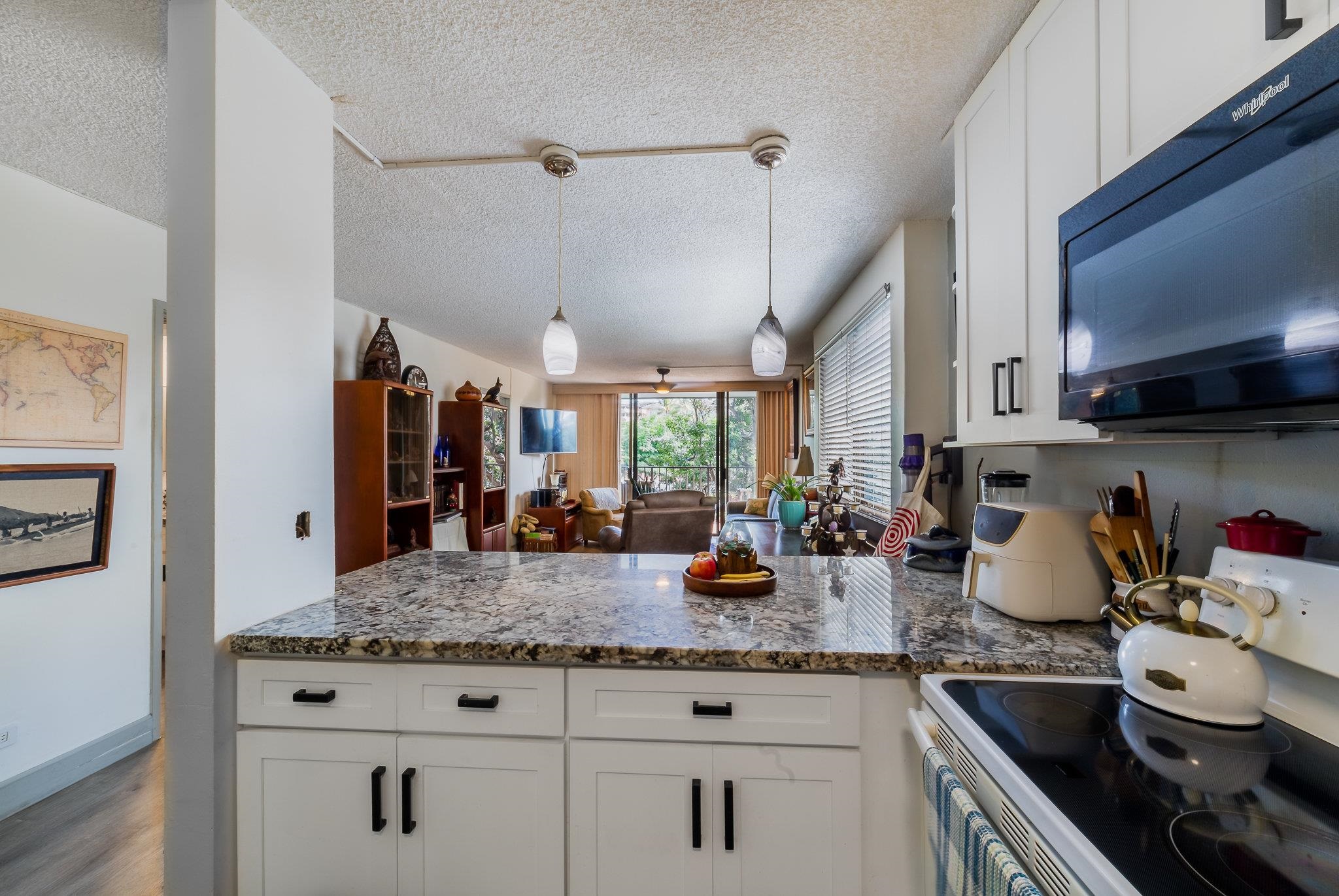 4310 Lower Honoapiilani Road, Unit 419 Lahaina, HI 96761 - Photo 5 of 32 a kitchen with sink stove and cabinets