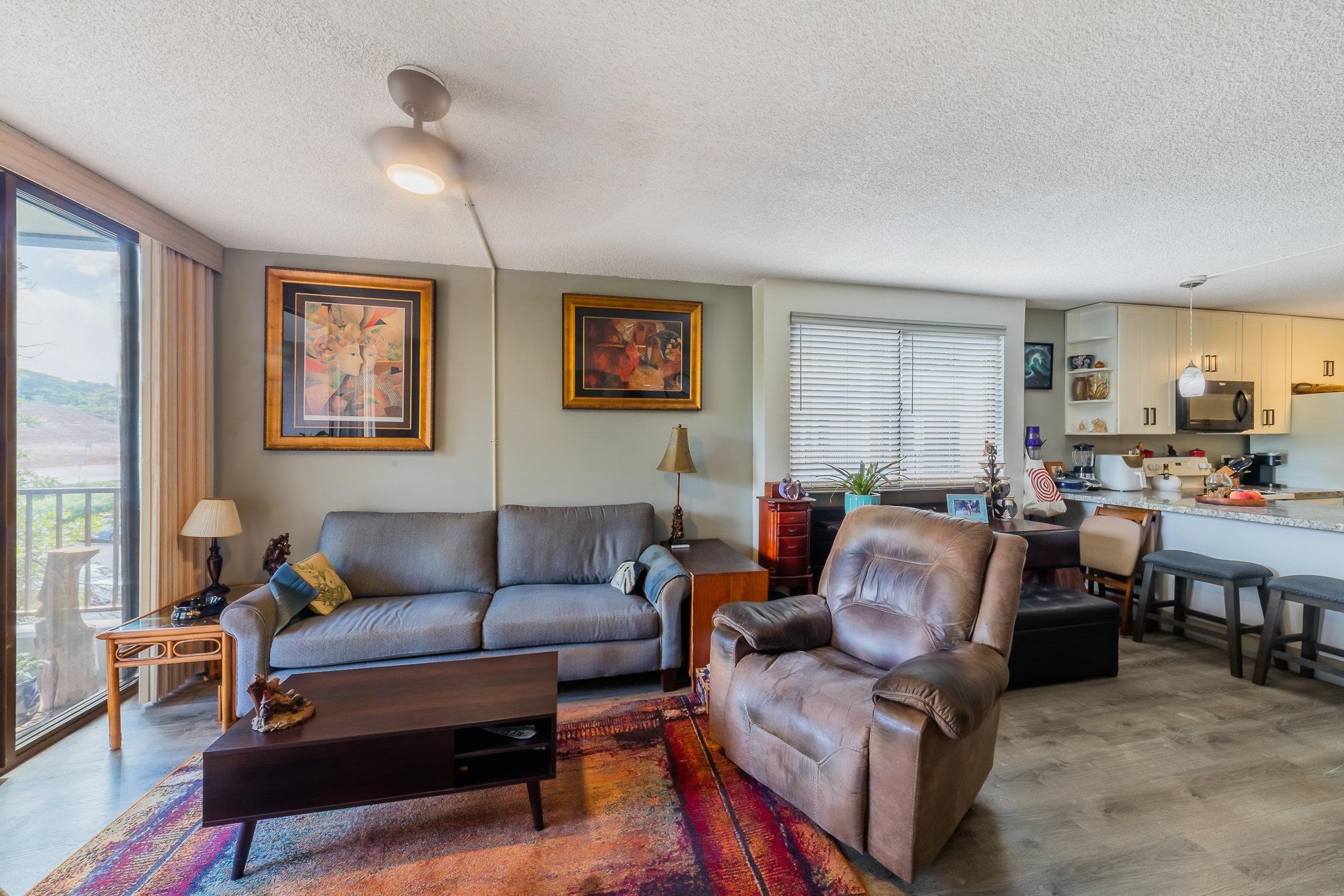 4310 Lower Honoapiilani Road, Unit 419 Lahaina, HI 96761 - Photo 9 of 32 a living room with furniture and a large window