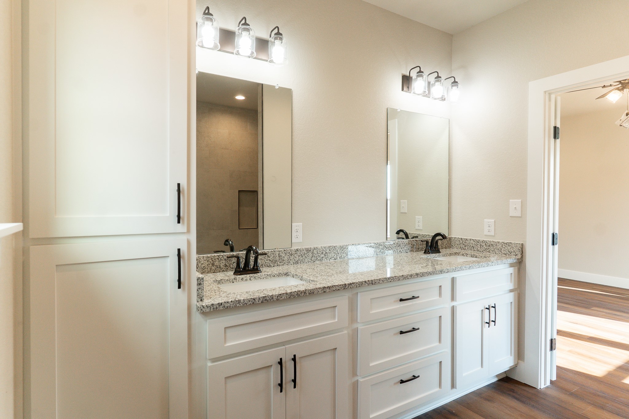 305 String Prairie Way Smithville, TX 78957 - Photo 14 of 26 a bathroom with a granite countertop double vanity sink and mirror
