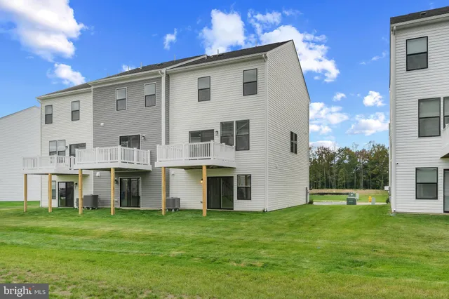 a front view of house with a garden