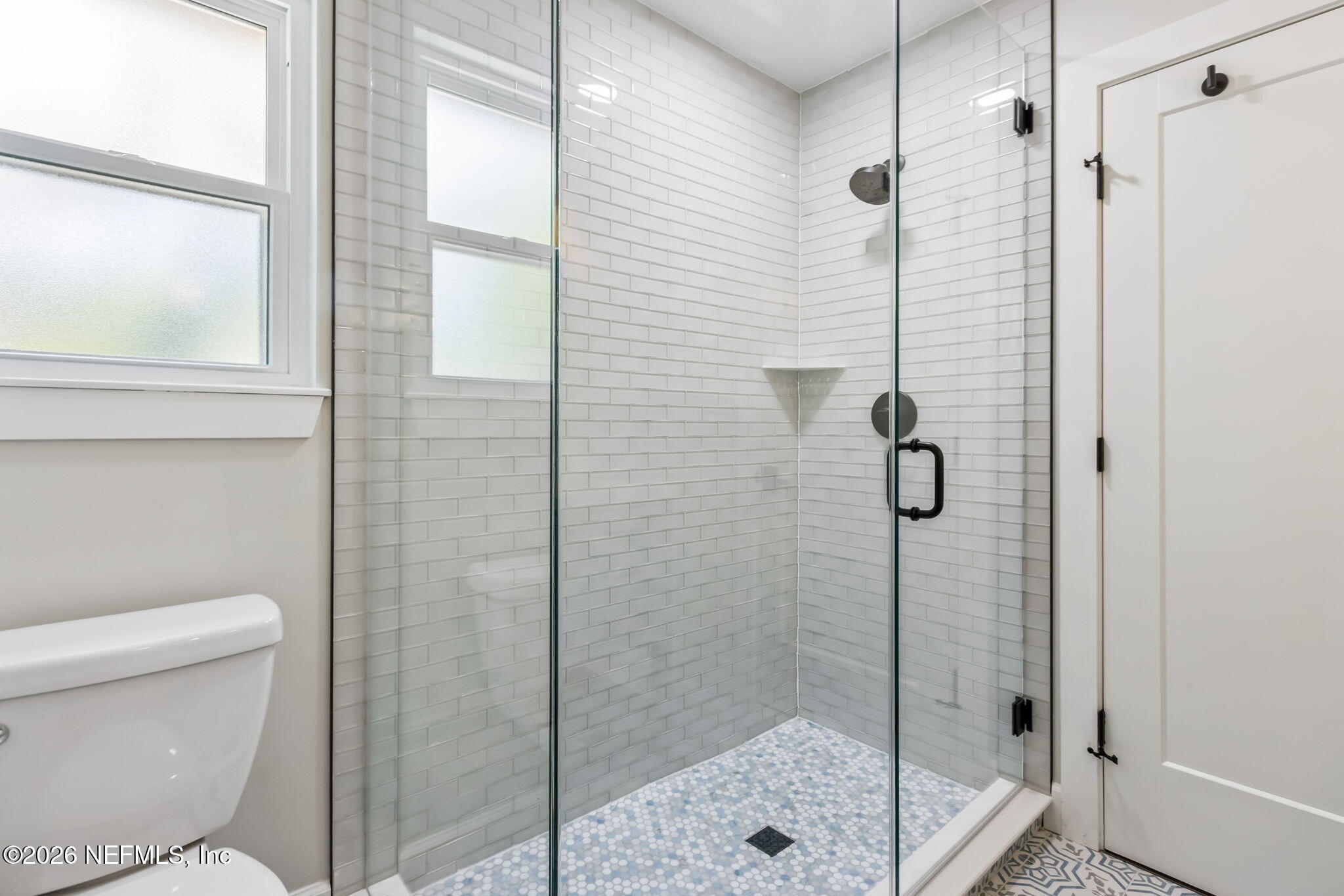 1877 Christopher Point Road South Jacksonville, FL 32217 - Photo 15 of 27 a bathroom with a shower and toilet