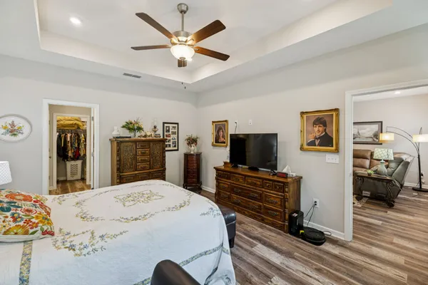 a spacious bathroom with a granite countertop double vanity sink a mirror and a shower