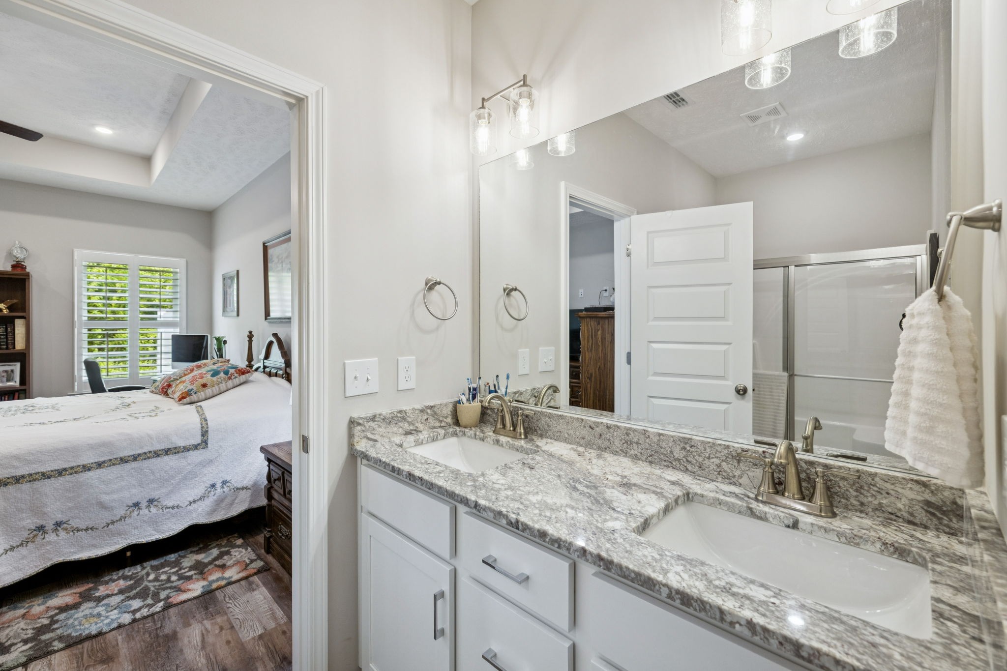 143 Creek Wood Road Manchester, TN 37355 - Photo 14 of 29 a spacious bathroom with a granite countertop double vanity sink a mirror and a shower