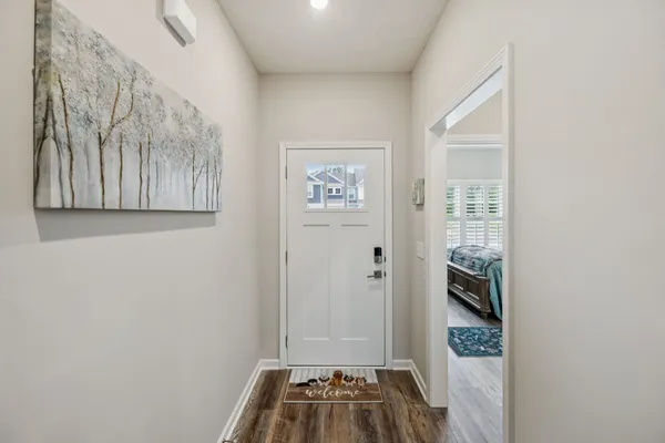 a large kitchen with granite countertop a large counter top stainless steel appliances and wooden floor