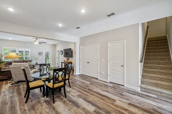 a living room with lots of furniture and kitchen view
