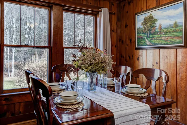a dining room with furniture a window and a chandelier
