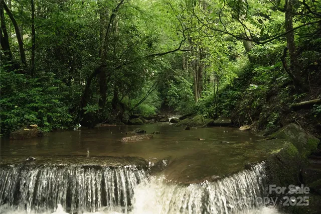 a backyard of a house with lots of green space and seating