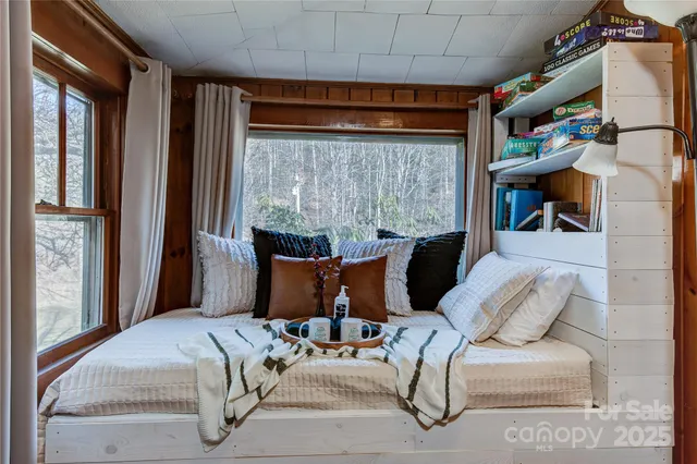 a bedroom with furniture and a window