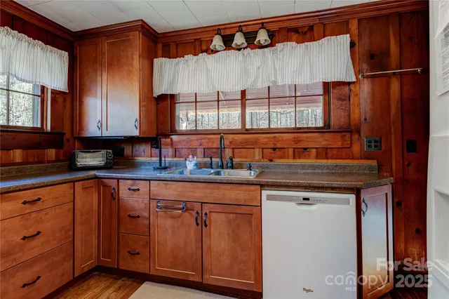a kitchen with stainless steel appliances granite countertop a sink and a cabinets