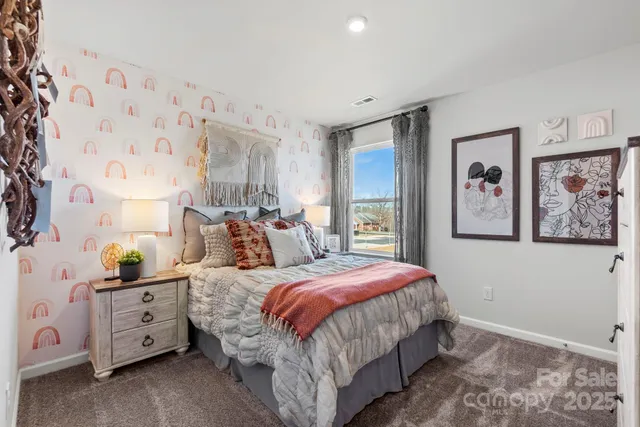 a bedroom with bed and painting on the wall