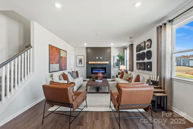 a living room with fireplace furniture and a wooden floor