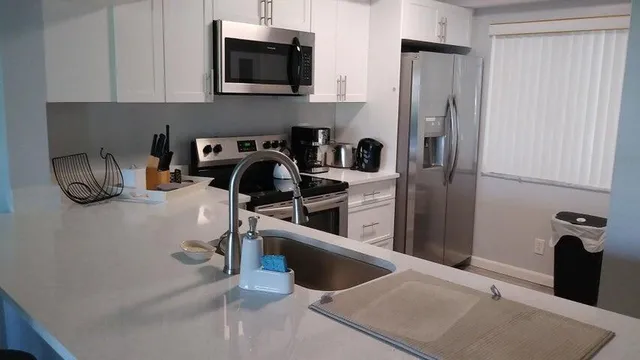 a kitchen with a refrigerator and a sink