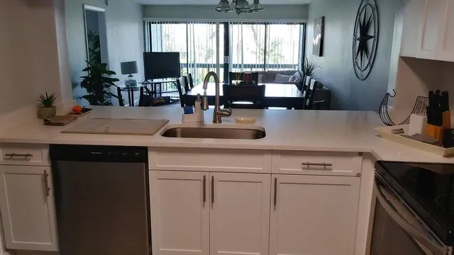 a view of a kitchen counter space a sink and a refrigerator