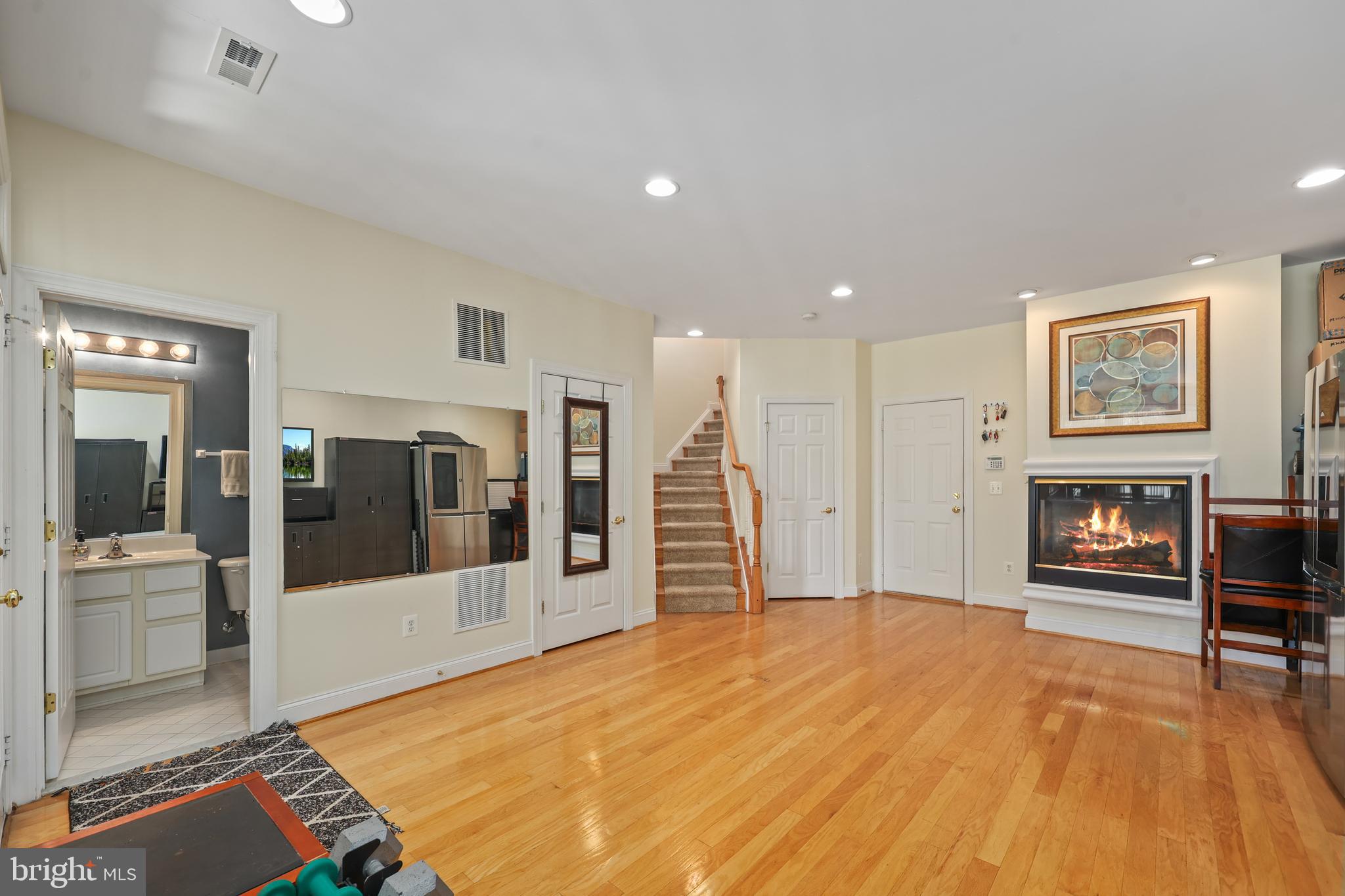 6806 Witton Circle Gainesville, VA 20155 - Photo 27 of 47 a spacious bedroom with a bed and a fireplace