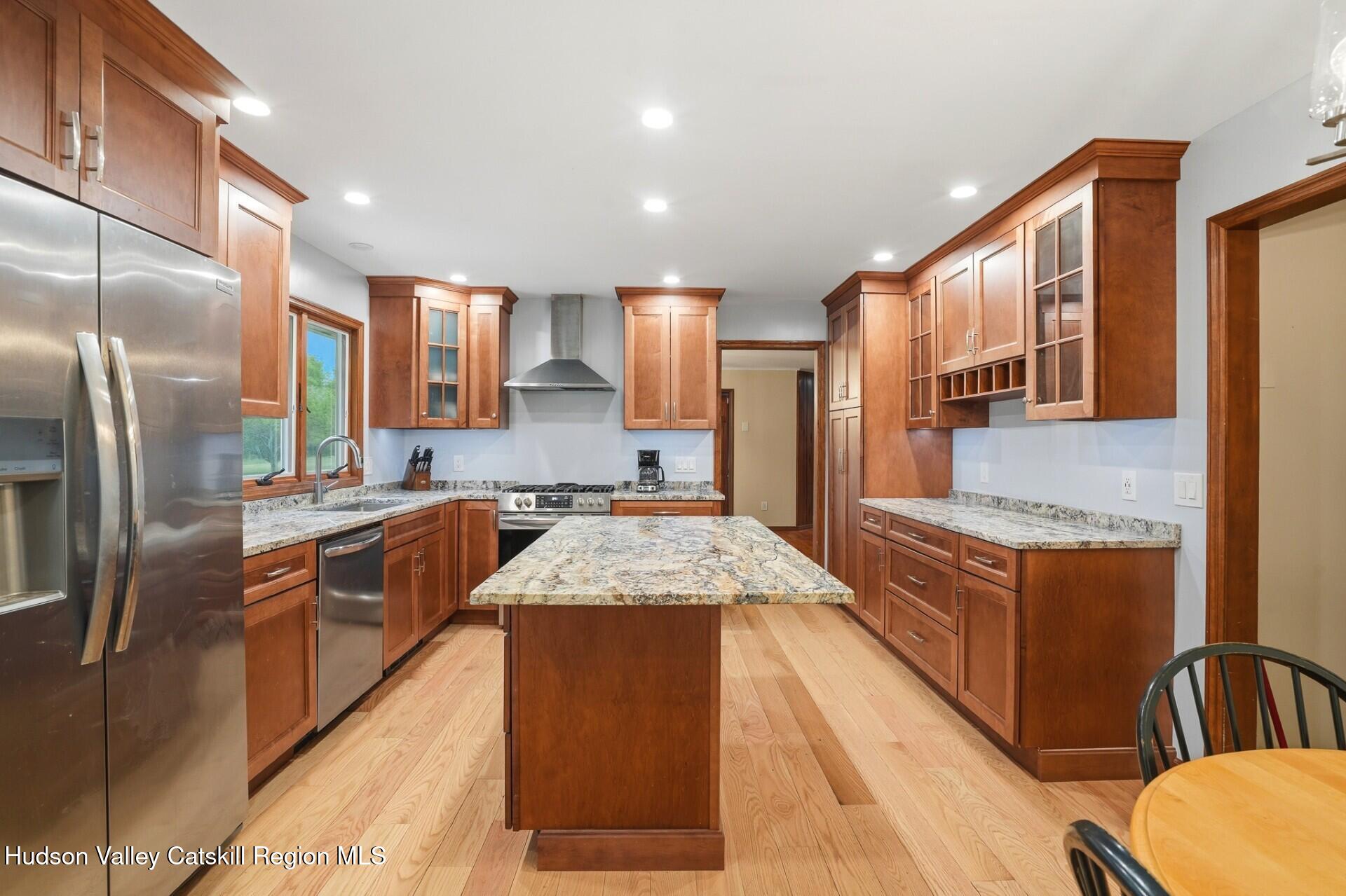 984 Blue Mountain Road Saugerties, NY 12477 - Photo 12 of 24 a large kitchen with stainless steel appliances granite countertop a stove a sink dishwasher and a refrigerator