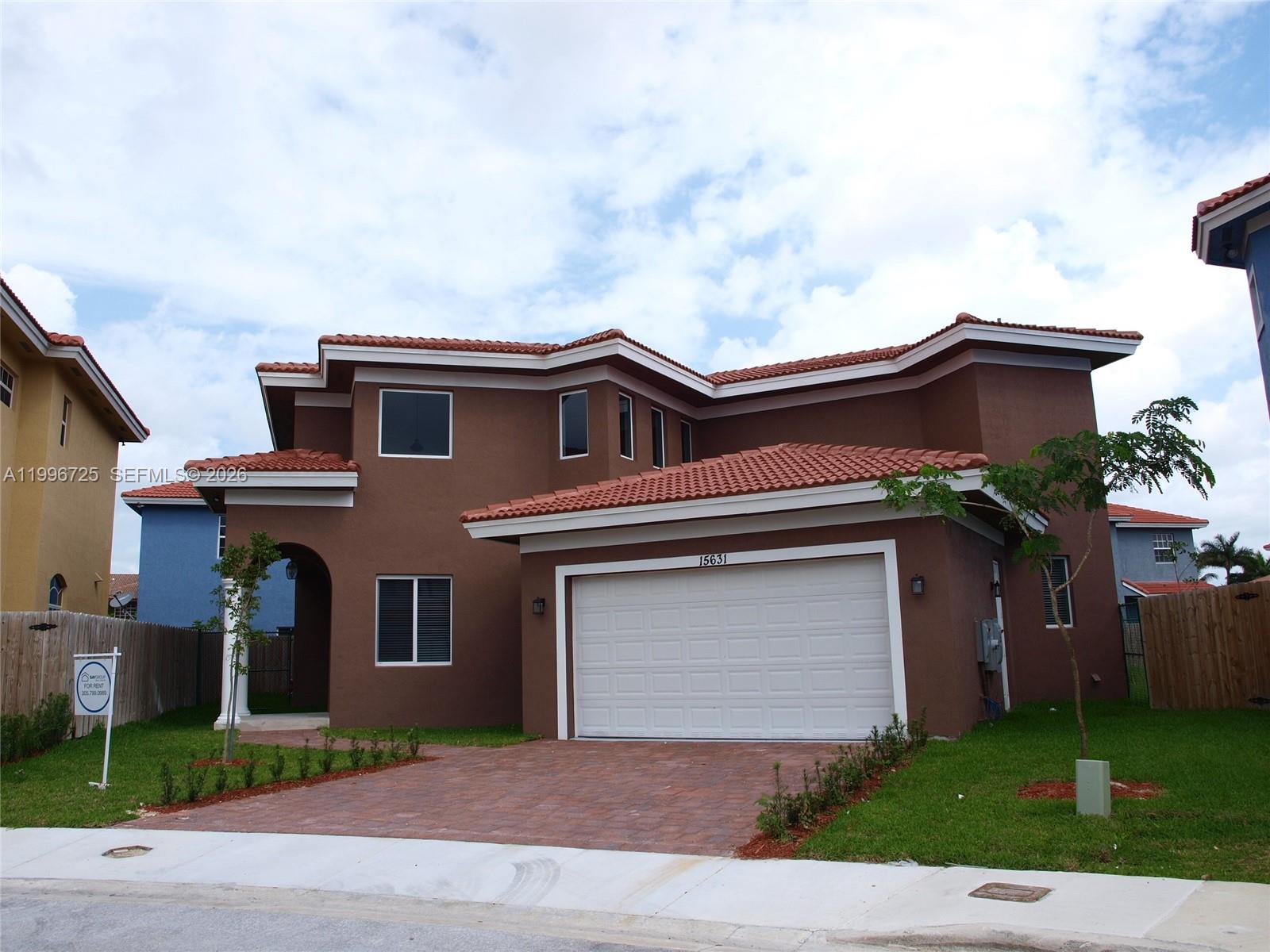 15631 Southwest 11th Terrace Miami, FL 33194 - Photo 1 of 43 a front view of a house with a yard and garage
