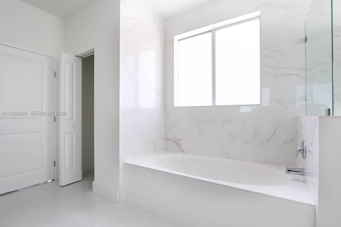 15631 Southwest 11th Terrace Miami, FL 33194 - Photo 13 of 43 a white bath tub sitting next to a window