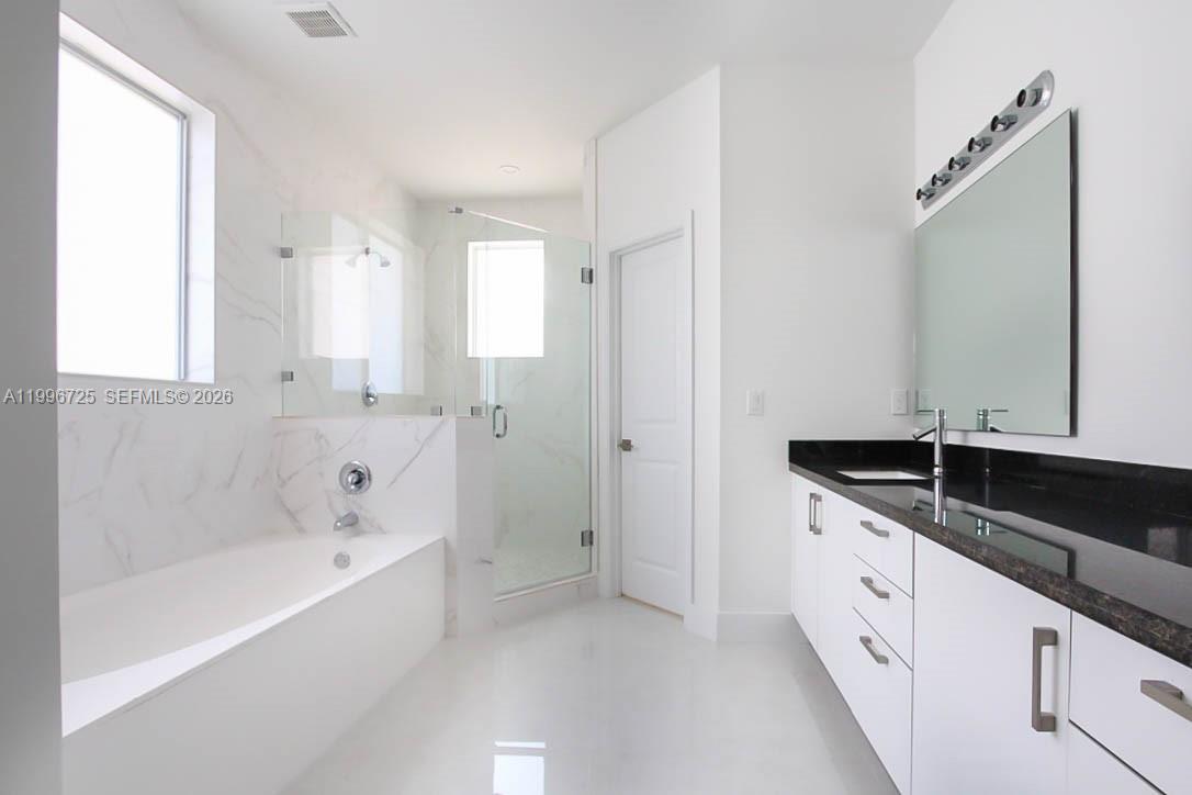 15631 Southwest 11th Terrace Miami, FL 33194 - Photo 22 of 43 a spacious bathroom with a granite countertop tub sink and mirror