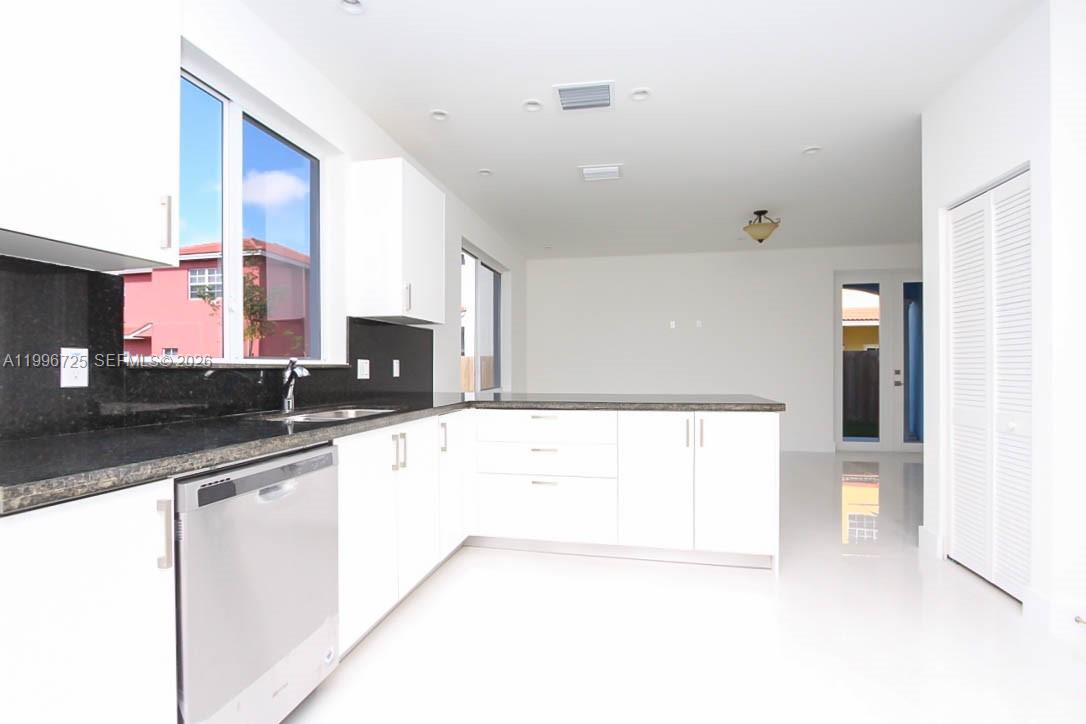 15631 Southwest 11th Terrace Miami, FL 33194 - Photo 40 of 43 a large kitchen with stainless steel appliances a sink a stove and a refrigerator