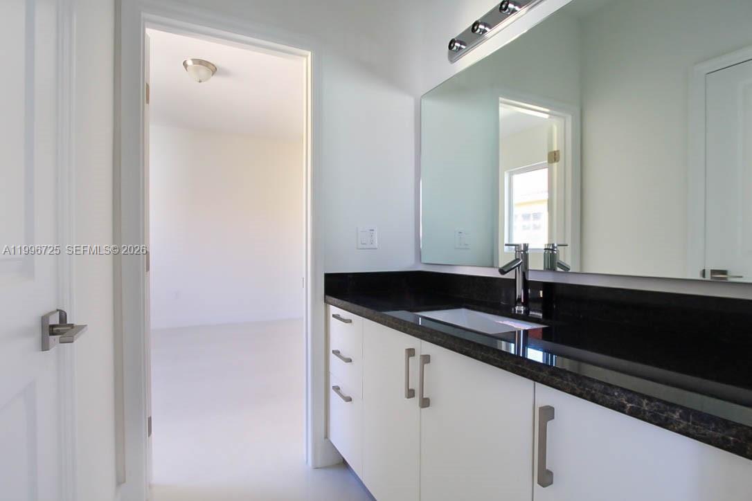 15631 Southwest 11th Terrace Miami, FL 33194 - Photo 41 of 43 a bathroom with a granite countertop sink and a mirror