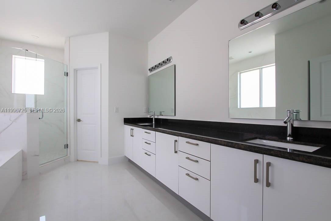 15631 Southwest 11th Terrace Miami, FL 33194 - Photo 6 of 43 a bathroom with a granite countertop sink and a mirror