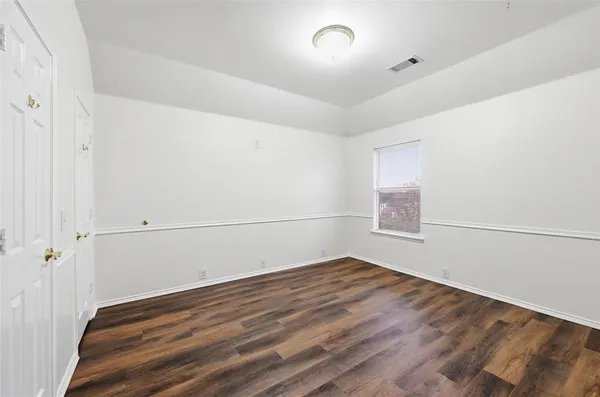 a view of a room with wooden floor