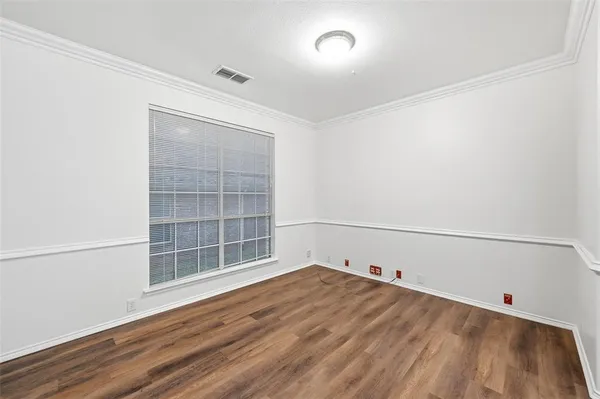 a view of a room with wooden floor and cabinet