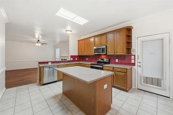 a kitchen with stainless steel appliances granite countertop a stove top oven a sink a counter top space and cabinets