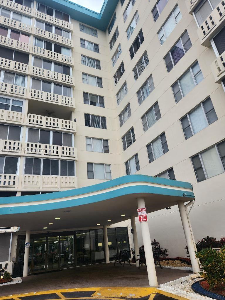 a front view of a building with parking space