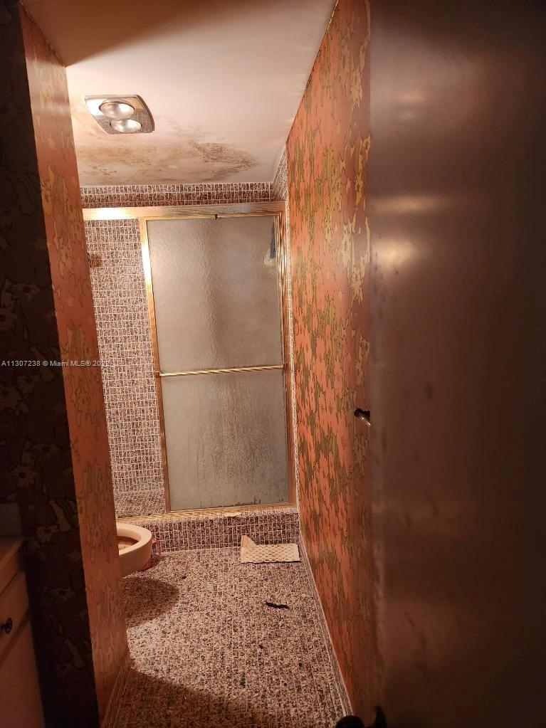 Hillcrest Hollywood, FL 33021 - Photo 3 of 10 a bathroom with a granite countertop shower and a sink