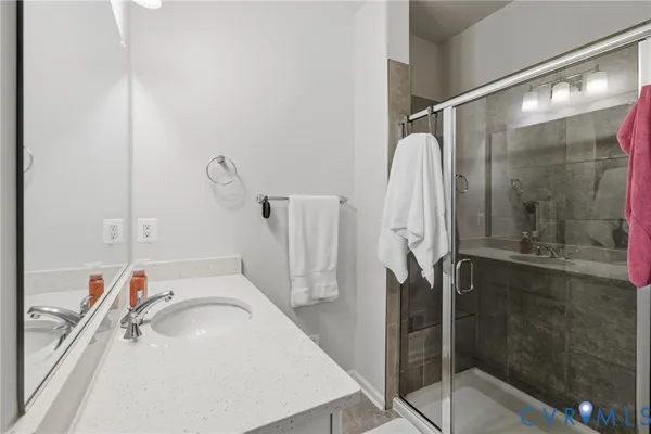 a bathroom with a sink vanity granite and a mirror