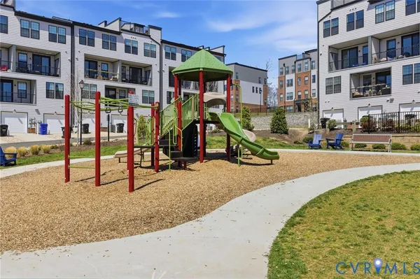 a view of building with cars parked