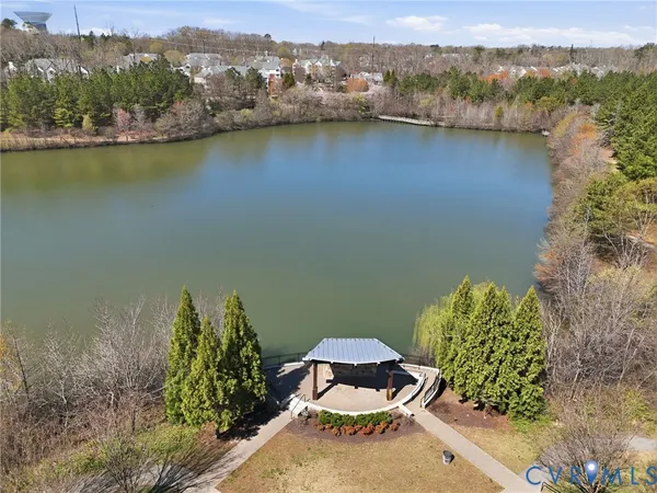 a view of a swimming pool with a patio and a yard