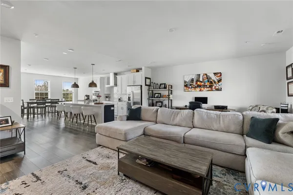a living room with furniture and view of kitchen