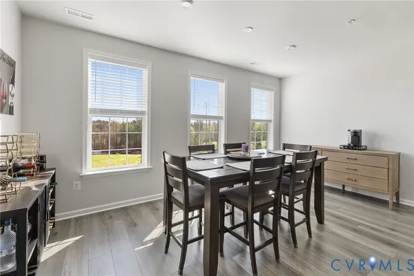 a view of a dining room with furniture and window