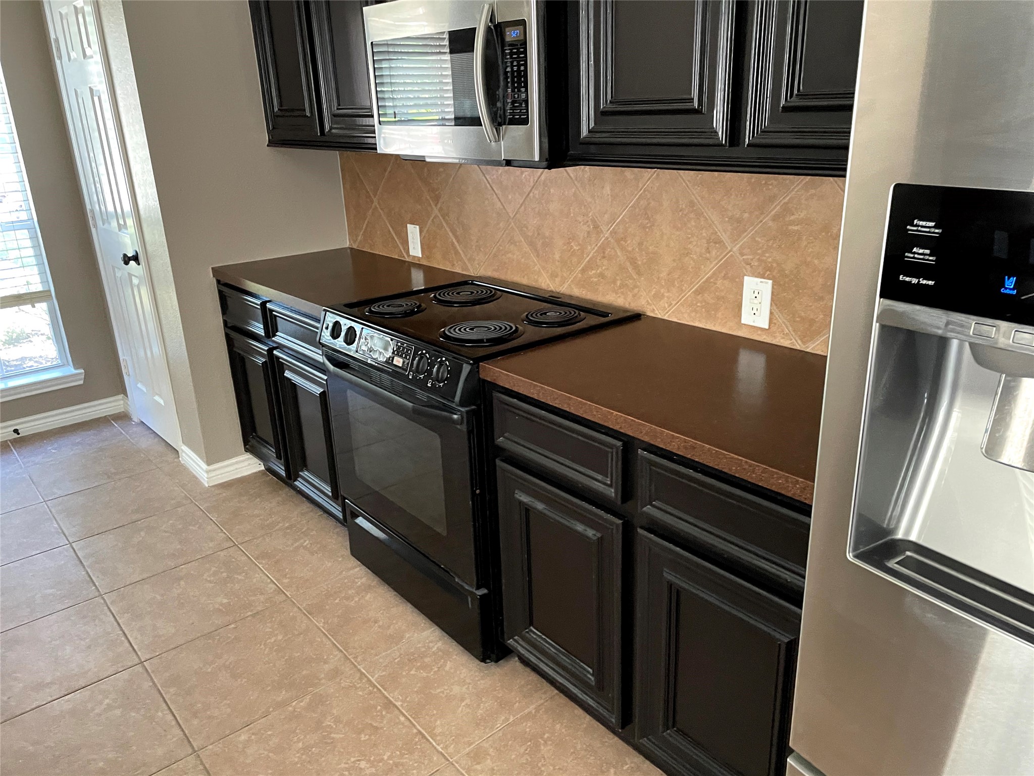 2314 Colonial Springs Lane Spring, TX 77386 - Photo 6 of 22 a kitchen with granite countertop a stove and a refrigerator