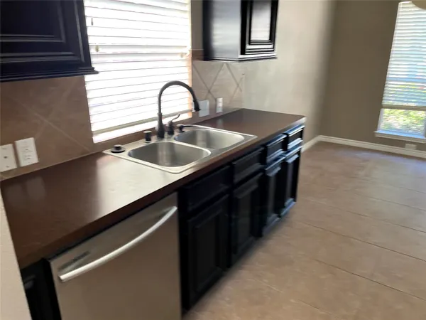 a kitchen with a sink and cabinets