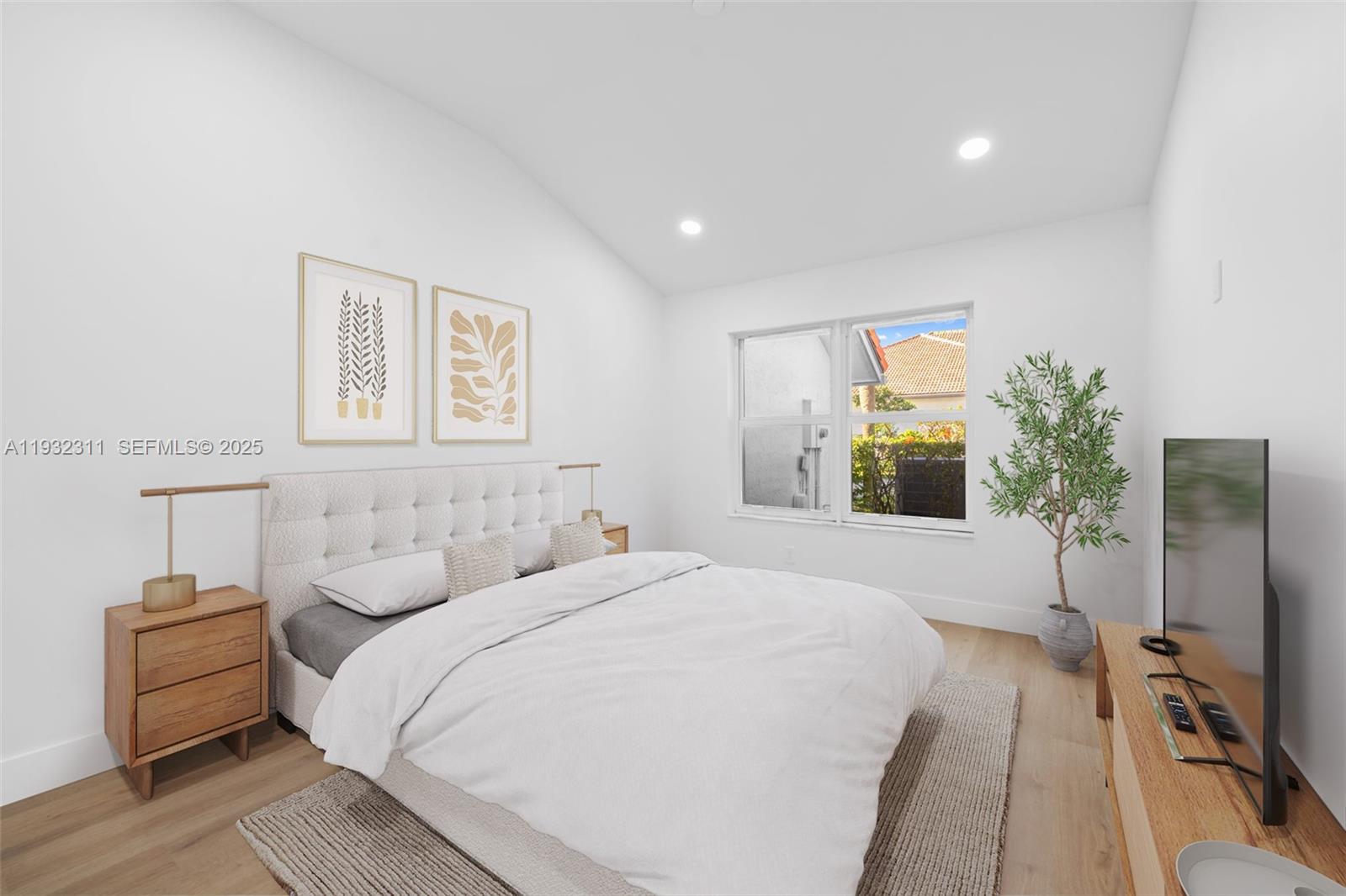 2014 Northwest 52nd Street Boca Raton, FL 33496 - Photo 14 of 26 a bedroom with a bed and a flat tv screen on dresser