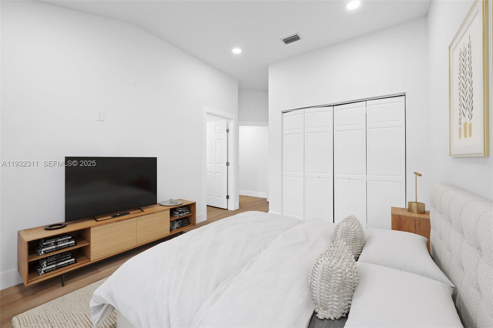 2014 Northwest 52nd Street Boca Raton, FL 33496 - Photo 15 of 26 a bedroom with bed and a flat screen tv