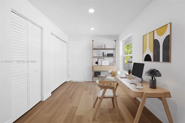 a view of a workspace with furniture and wooden floor
